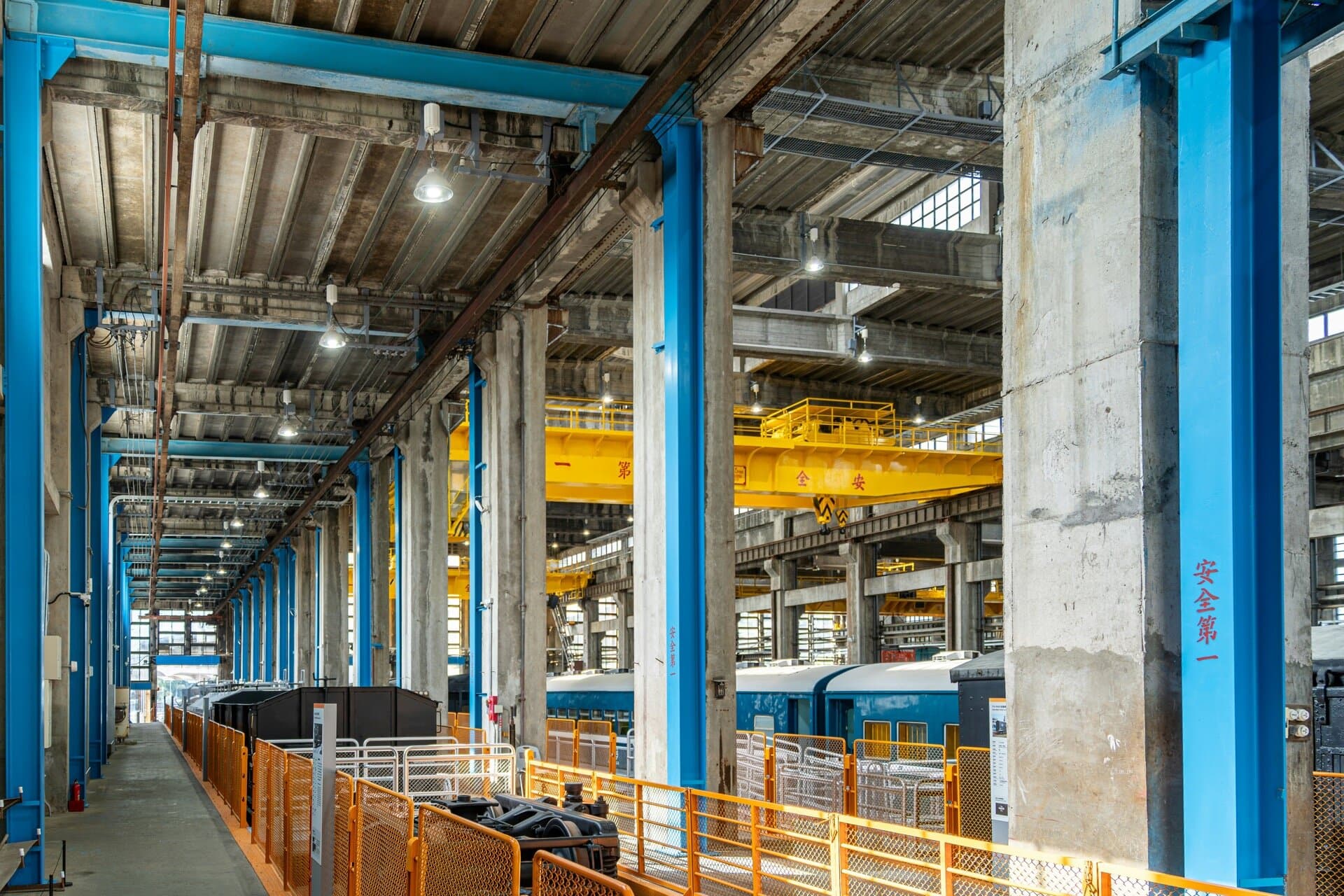 Interior of a large industrial facility with steel beams and overhead crane